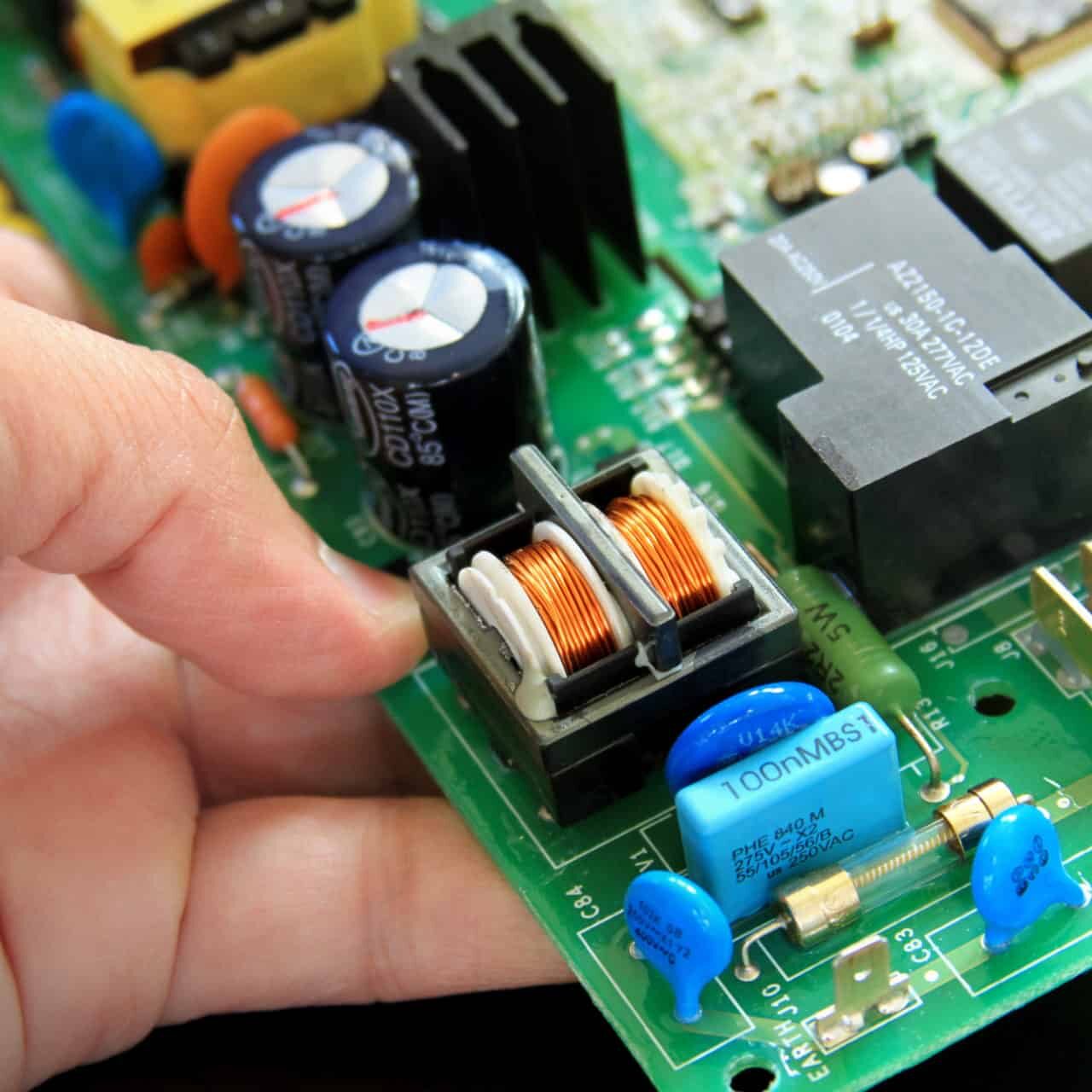 technician with a circuit board iten electronics market